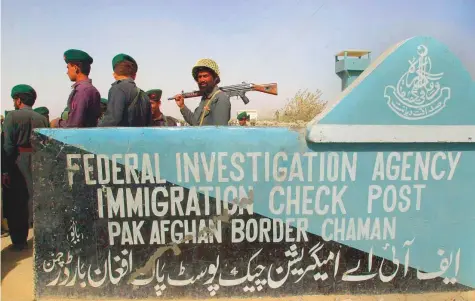  ?? Rex Features ?? Armed Pakistani border guards keep watch at the Afghanista­n-Pakistan border in the town of Chaman, Pakistan. According to UNHCR reports 10,000 Afghan refugees have crossed the border in the last few days.