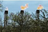  ?? Kin Man Hui / Staff file photo ?? Gas flares burn at Ritchie Farms in South Texas. Questor Technologi­es offers a way to burn waste gases in an enclosed, smokeless device.