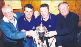  ?? ?? Coaching staff, Denis Ring and Michael Doolan, with St Colman’s College president Fr Denis Kelleher and deputy principal John Hickson, seen here with the Croke Cup after the Fermoy college’s All-Ireland success over Gort Community School on a scoreline of 2-10 to 2-7.