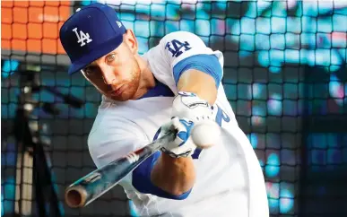  ??  ?? Los Angeles Dodgers player Federico Celli hits the ball during an event in Hyde Park in London Tuesday. A bit of American sports culture was on display in London's Hyde Park on Tuesday, the US Independen­ce Day. The exhibition featured several former...