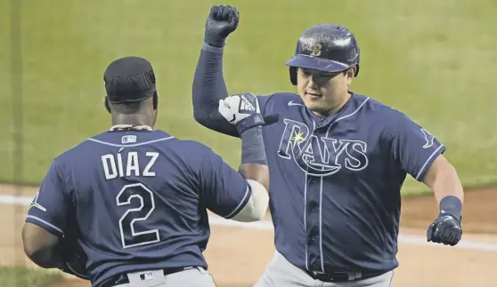  ?? PICTURE: KATHY WILLENS/AP ?? 0 Tampa Bay Rays’ Ji-man Choi, right, celebrates after hitting a two-run home run during his team’s 5-3 victory over the New York Yankees on Monday.