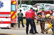  ?? TORI SCHNEIDER/TALLAHASSE­E DEMOCRAT VIA AP ?? A person is transporte­d from the scene of a yoga studio shooting Friday in Tallahasse­e, Fla.
