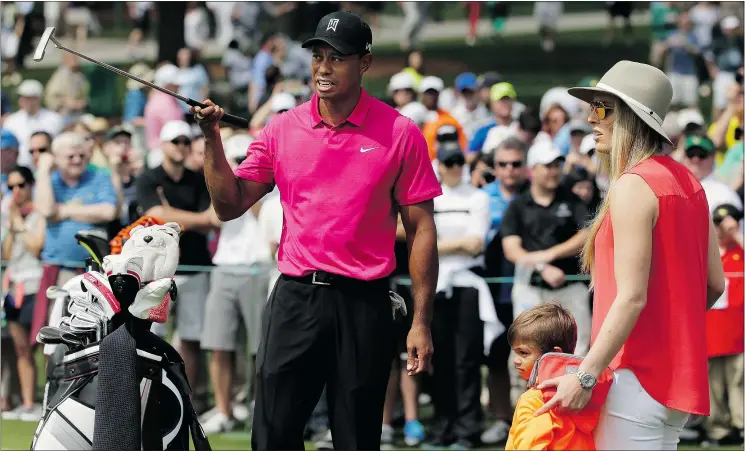  ?? — THE ASSOCIATED PRESS ?? Tiger Woods talks with his girlfriend Lindsey Vonn and his son, Charlie, during a practice round for the Masters golf tournament on Tuesday.