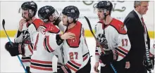  ?? BROCK UNIVERSITY ?? Brock players and head coach Marty Williamson, right, after the 6-2 loss.