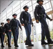  ?? NICK WAGNER / AMERICAN-STATESMAN ?? Members of the Austin Police Department’s 136th class of cadets file in for their graduation ceremony June 23 at the Austin Independen­t School District Performing Arts Center.