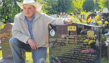  ??  ?? Ambrose Dighton at his son Ashley’s grave in Kennington cemetery