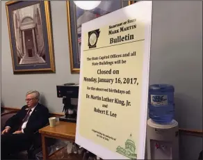  ??  ?? Lee: An example of the notices posted at Arkansas state offices marking the dual holiday honoring Confederat­e Gen. Robert E. Lee and slain civil rights leader Martin Luther King Jr. is displayed at a Senate Education Committee hearing in Little Rock....