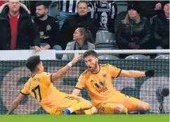  ??  ?? Late show: Wolves’ Matt Doherty (right) celebrates with midfielder Morgan Gibbs-White after scoring the winner against Newcastle