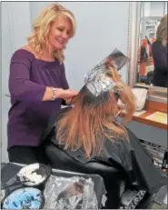  ?? PHOTO COURTESY OF SALON EVOLVE ?? Salon Evolve owner Kim McQuillan colors a client’s hair at her Limerick salon. The foils, as well as left over color are now being recycled by Salon Evolve as part of a salon industry recycling program. Salon Evolve is Green Circle Salon certified, and is recycling its salon waste including hair clippings, left over product, plastic bottles, color tubes and broken styling tools.