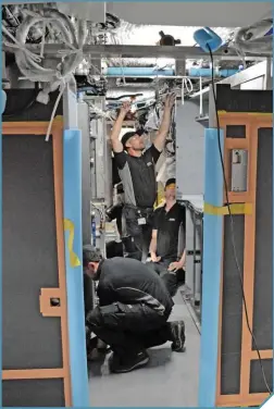  ??  ?? Above: Staff work on the fitting of a Class 800/3 kitchen at Newton Aycliffe. RICHARD CLINNICK.