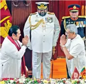  ??  ?? Sri Lankan President Gotabaya Rajapaksa, right, greets his brother Mahinda Rajapaksa, left, after appointing him as Prime Minister on Thursday