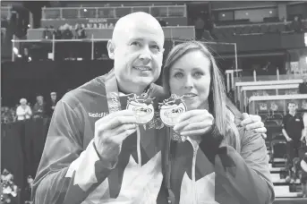  ?? CP PHOTO ?? Team Koe skip Kevin Koe and Team Homan skip Rachel Homan celebrate their wins at the 2017 Roar of the Rings Olympic Curling Trials in Ottawa.