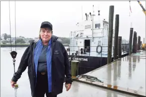  ?? Arnold Gold / Hearst Connecticu­t Media ?? Copps Island Oysters farm stand manager Patty King by the oyster dredging boat Jeanne Christine on Quinnipiac Avenue in New Haven last week.