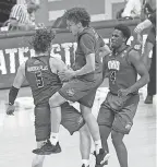  ?? ROBERT GODDIN/ USA TODAY SPORTS ?? Ohio’s Ben Vander Plas, Jason Preston and Dwight Wilson III ( 4) celebrate the upset of reigning men’s champion Virginia.