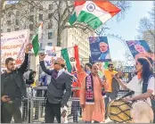  ??  ?? Indian community people welcome PM Modi in London on Wednesday.