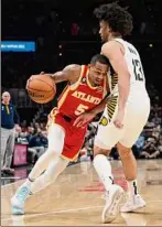  ?? Hakim Wright Sr. / Associated Press ?? Atlanta guard Dejounte Murray drives against Indiana forward Jordan Nwora during the first half Saturday. Murray had 20 points, and Nwora had 33.