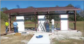  ?? Photo by Susan Holland ?? Workers for Amos Riordan Constructi­on and Remodeling were busy Oct. 24 constructi­ng a restroom building on the grounds of the Hiwasse Community Center. Restrooms will be roofed to match the recently completed pavilion nearby. Sidewalks link the...