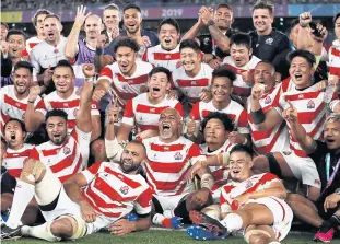  ?? AFP ?? Japan players celebrate their win against Scotland in Yokohama on Sunday.