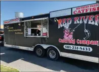  ?? (Arkansas Democrat-Gazette/Eric E. Harrison) ?? Red River Catering Co.’s food truck parks more or less permanentl­y on a former used-car lot at West Third and Victory streets in Little Rock.