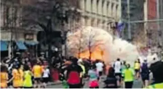  ?? WBZ TV/ THE ASSOCIATED PRESS ?? In this image from video provided by WBZ TV, spectators and runners run from what was described as twin explosions that shook the finish line of the Boston Marathon Monday.