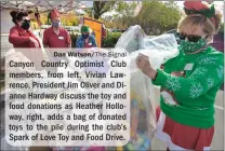  ?? Dan Watson/ The Signal ?? Canyon Country Optimist Club members, from left, Vivian Lawrence, President Jim Oliver and Dianne Hardway discuss the toy and food donations as Heather Holloway, right, adds a bag of donated toys to the pile during the club’s Spark of Love Toy and Food Drive.