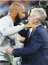  ??  ?? Henry embraces France manager Didier Deschamps before the game on Tuesday
