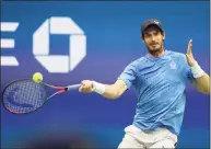  ?? Elsa / Getty Images ?? Andy Murray returns a shot against Stefanos Tsitsipas during their men’s singles first-round match at the U.S. Open on Monday.