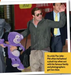  ?? ?? As a kid, Pax JoliePitt often hid behind a plush toy when out with his famous family and photograph­ers got too close.