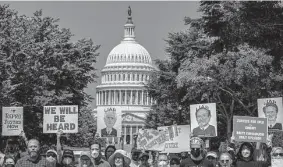  ?? Gemunu Amarasingh­e/Associated Press file photo ?? Abortion-rights advocates protest justices Neil Gorsuch, Samuel Alito and Brett Kavanaugh on June 13 outside the U.S. Supreme Court.