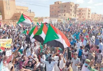  ?? GETTY-AFP ?? Tens of thousands of Sudanese took to the streets across the country Saturday, including in the capital Khartoum’s twin city of Omdurman, above, in the largest pro-democracy protest yet since the military seized control last week. Three protesters were killed and dozens injured by security forces. The military takeover has derailed a halting transition to democracy.