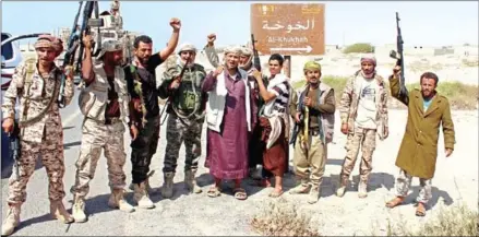  ?? SALEH AL-OBEIDI/AFP ?? Yemeni fighters loyal to the Saudi-backed Yemeni president stand on a road leading to the town of Khokha, retaken from ShiiteHuth­i rebels, about 120km south of the Huthi rebel-held Red Sea port of Hodeida, last year.