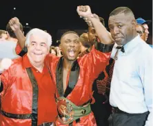  ?? Ron Frehm / Associated Press 1993 ?? With trainer Lou Duva (left), Pernell Whitaker celebrates after beating James McGirt at Madison Square Garden.