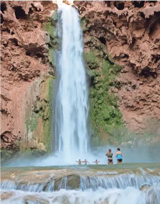  ?? PAT SHANNAHAN/ REPUBLIC ?? Campers cool off at Mooney Falls, one of the Havasupai waterfalls.