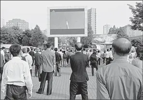  ?? AP/JON CHOL JIN ?? North Koreans watch Monday as a news broadcast on the test-launch of a Pukguksong-2 missile is shown on a screen in front of the railway station in Pyongyang.