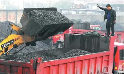  ?? TIAN SHENG / FOR CHINA DAILY ?? A heavy-duty lorry receives coal load at a yard in Huaibei, Anhui province. Prices of coal and metals have risen this year, boosting profits and shares of listed companies in the sectors concerned.