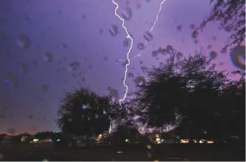  ?? Ahmed Ramzan/Gulf News ?? Lightning lights up the night sky in Sharjah late last evening as rains struck most of the UAE.