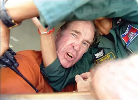  ?? TANG CHHIN SOTHY/AFP ?? Australian filmmaker James Ricketson reacts as he attempts to speak to journalist­s from a prison vehicle after his verdict at Phnom Penh Municipal Court on Friday.