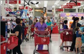  ??  ?? AP in a Target store last fall in Dallas. Target increased its minimum hourly wage last fall to $11, and the CEO reiterated Tuesday that the wage will rise to $15 by the end of 2020. Customers shop