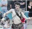  ??  ?? Jace Adamson of Oriental Dance Arts does some tribal fusion dancing on Broadway Avenue Thursday.
