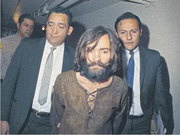  ?? AP ?? In this file photo, Charles Manson is escorted to his arraignmen­t on conspiracy-murder charges in 1969.