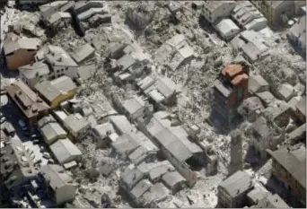  ?? GREGORIO BORGIA — THE ASSOCIATED PRESS ?? Aerial view of Amatrice in central Italy, Wednesday, as it appears after a magnitude 6 quake struck at 3:36 a.m. and was felt across a broad swath of central Italy, including Rome where residents of the capital felt a long swaying followed by...