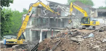  ??  ?? ●●Demolition work at Springmoun­t Mill, Cheadle Heath