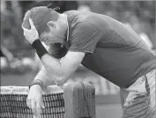  ?? Christophe Ena Associated Press ?? A DEJECTED Juan Martin del Potro gathers his thoughts at the net after losing the first set Saturday.