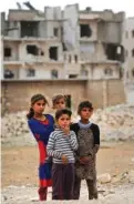  ??  ?? Children stand on the outskirts of al-Bab, northern Syria.