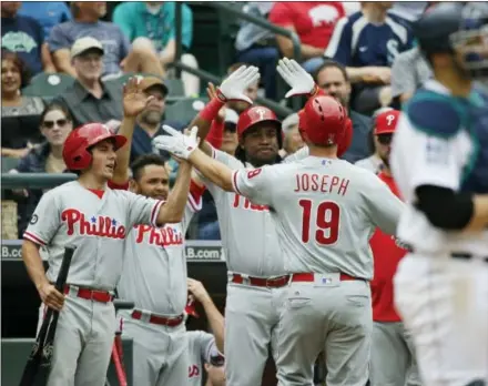  ?? TED S. WARREN — THE ASSOCIATED PRESS ?? The Phillies’ Tommy Joseph is greeted at the dugout after he hit a solo home run to lead off the ninth inning in Seattle Wednesday, tying the game. The Phillies would tack on one more run in the inning and win 5-4, sweeping a two-game set with the...