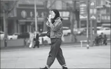  ?? PROVIDED TO CHINA DAILY ?? A pedestrian enjoys her ice cream at a shopping street in Changchun, capital of Jilin province, on April 17.