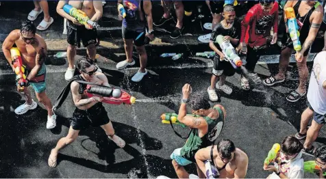  ?? | CHALINEE THIRASUPA Reuters ?? LOCALS and tourists play with water as they celebrate the Songkran Holiday marking the Thai New Year in Bangkok.