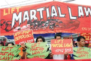  ?? (Romeo Ranoco/Reuters) ?? ACTIVISTS DISPLAY placards calling for lifting of martial law in the southern Philippine­s during a protest outside the presidenti­al palace in Manila yesterday.