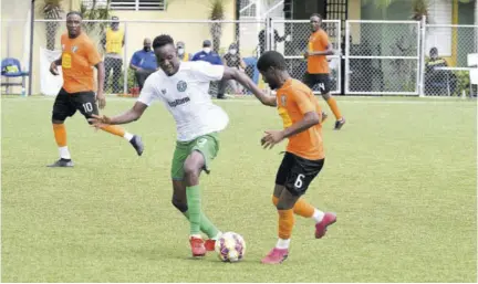  ?? (Photos: Joseph Wellington) ?? Vere United’s Kenroy Lumsthen (left) and Horatio Morgan of tivoli Gardens challenge for possession of the ball during their Jamaica Premier League second-leg quarter-final contest at the UWI-JFF Captain Horace Burrell Centre of Excellence yesterday.