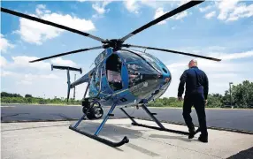  ?? [FRED SQUILLANTE/DISPATCH] ?? Lt. Jack Harris approaches a Columbus Division of Police helicopter at the department’s helipad on the Hilltop.